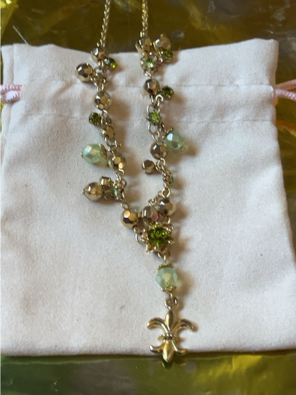 Gold-Tone Necklace with Green Crystal Accents and Fleur-de-Lis Pendant